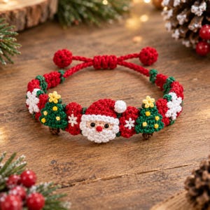 May include: A handmade macrame bracelet featuring a central Santa Claus face, flanked by green Christmas trees with yellow star toppers and white snowflake motifs. The band is constructed from red cord with adjustable knotted ends.