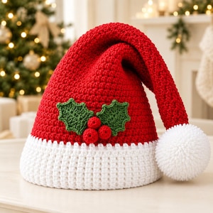 May include: A red crocheted Santa hat featuring a white brim and a white pom-pom at the tip. The front of the hat is decorated with two green crocheted holly leaves and three small red crocheted berries centered on the red fabric surface.