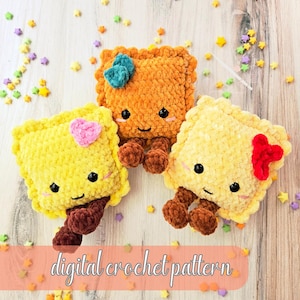 May include: Three square plush toys made of yellow and orange yarn, each featuring black bead eyes, a small smile, and brown dangling legs. One has a pink heart, one a teal bow, and one a red bow. The text digital crochet pattern is visible.