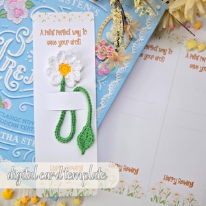 May include: A white bookmark with a crocheted daisy and green stem and leaf. The bookmark has the text "A Polar Perfect way to save your spoil" and "digital card template".