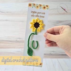 May include: A crochet sunflower bookmark with a yellow flower, brown center, and green stem and leaf. The bookmark is attached to a white card with the text "Brighten your book with a little bloom!" and "digital crochet pattern".
