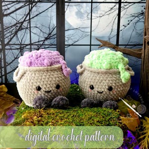 May include: Two crocheted plush cauldrons with smiling faces, black eyes, and pink cheeks. One cauldron has purple textured yarn bubbling over the top, and the other has light green yarn. Both have dark grey feet and the text digital crochet pattern.