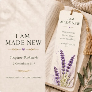 May include: A rectangular paper bookmark featuring the text I AM MADE NEW, the scripture If anyone is in Christ, he is a new creation, and 2 CORINTHIANS 5:17. The design includes a watercolor illustration of purple lavender and a gold tassel.
