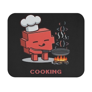 May include: A rectangular black mouse pad featuring a red pixelated character wearing a white chef hat, holding a frying pan over a fire. Steam rises from the pan in the form of programming code symbols. The word COOKING is printed in red pixels.