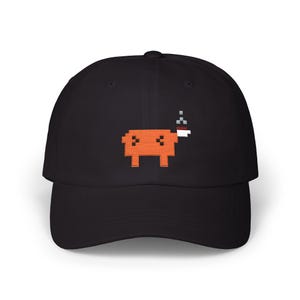 May include: A black baseball cap featuring an embroidered pixel art design of an orange four-legged creature with a white and red head detail and small grey smoke-like pixels rising above it, centered on the front panel of the hat.