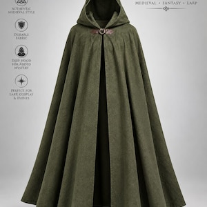 May include: An olive green hooded cloak featuring a brown leather-like strap closure at the neck. The text on the image reads: HOODED CLOAK, MEDIEVAL, FANTASY, LARP, AUTHENTIC MEDIEVAL STYLE, DURABLE FABRIC, DEEP HOOD FOR ADDED MYSTERY, PERFECT FOR LARP, COSPLAY & EVENTS.