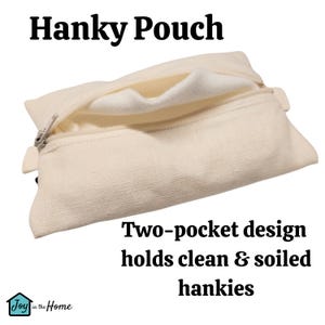 May include: A white canvas pouch with a zipper opening. The pouch has two compartments, one for clean hankies and one for soiled hankies. The text "Hanky Pouch" is printed on the top of the pouch. The text "Two-pocket design holds clean & soiled hankies" is printed below the pouch.