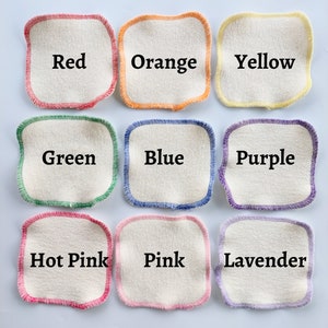 May include: Nine cotton rounds with colored stitching, each labeled with a color: Red, Orange, Yellow, Green, Blue, Purple, Hot Pink, Pink, and Lavender.