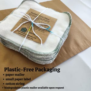 May include: A stack of white cotton makeup remover pads with green stitching, wrapped in a brown paper mailer with a white string and a small paper label that reads "Bamboo Cotton Wipes". The text "Plastic-Free Packaging" is written in black on a brown background below the image. The text below the heading lists the packaging materials: paper mailer, small paper label, cotton string, and biodegradable plastic mailer available upon request.