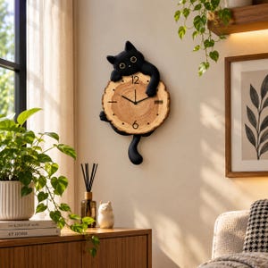May include: A wall clock featuring a black cat figure holding a circular wood slice with visible grain patterns. The clock face has black hands, the numbers 6 and 12, and simple black dots for the remaining hour markers, with a long black cat tail.
