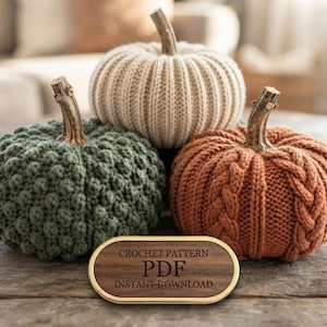 May include: Three decorative pumpkins made of yarn with wooden stems. One is cream with a ribbed texture, one is dark green with a bobble stitch pattern, and one is burnt orange with a cable knit design. An oval sign reads CROCHET PATTERN PDF INSTANT DOWNLOAD.