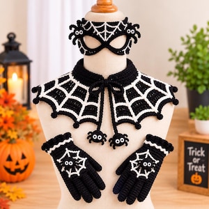May include: A black and white crocheted set featuring a spiderweb mask, a spiderweb collar with two dangling spider charms, and a pair of matching gloves with spiderweb and spider motifs. The set is displayed on a mannequin torso.