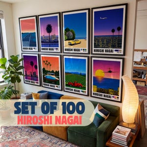 May include: A collection of eight framed art prints by Hiroshi Nagai displayed on a wall above a sofa. Each print features vibrant, stylized landscapes with bold colors, including scenes with cars, airplanes, palm trees, and city skylines at sunset.