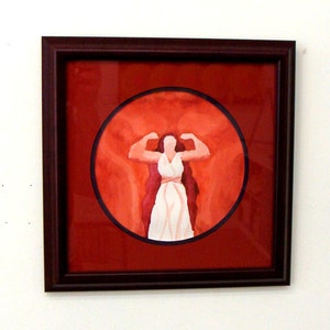 May include: A framed watercolor painting of a woman with long red hair, wearing a white dress, standing with her arms raised in a flexing pose. The background is a red circle.