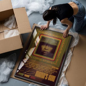 May include: A framed rectangular poster featuring a portrait of Erykah Badu centred within concentric green, yellow, and red rectangular borders. The text reads Erykah Badu Mama's Gun, with a tracklist including Bag Lady and Green Eyes.
