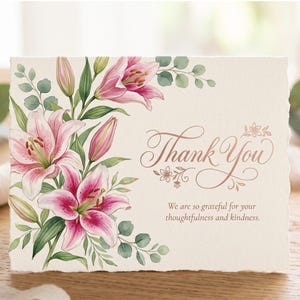 May include: A rectangular greeting card with a textured off-white surface featuring a watercolor illustration of pink lilies and green eucalyptus leaves on the left. The text Thank You and We are so grateful for your thoughtfulness and kindness.