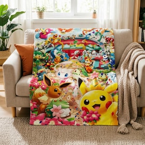 May include: A rectangular throw blanket featuring a vibrant, multi-coloured illustration of numerous Pokémon characters, including Pikachu, Eevee, and Mew, set against a festive, floral-filled background with various creatures in a dynamic scene.