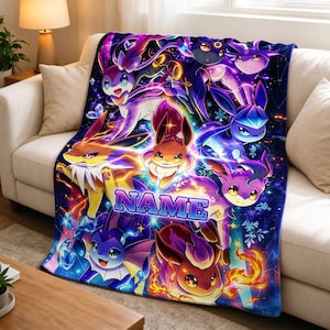May include: A plush throw blanket featuring a vibrant, colorful graphic print of multiple Eevee evolution characters against a dark, starry cosmic background. The center of the blanket displays the word NAME in bold, blue, blocky letters.