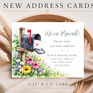 May include: A 4.25 inch by 5.5 inch moving announcement card featuring a watercolor illustration of a mailbox on a wooden post surrounded by colorful wildflowers. The text reads NEW ADDRESS CARDS, We've Moved!, Please note our new address, Scott & Hannah Jacobs, 1234 Your Address, City, State 12345, 123.456.7890.