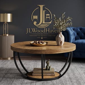 May include: A round wooden coffee table with a natural wood grain top and a lower shelf supported by a black metal frame. The table holds a gold bowl with chocolates, a geometric vase with greenery, and two books titled Frank Lloyd Architect.
