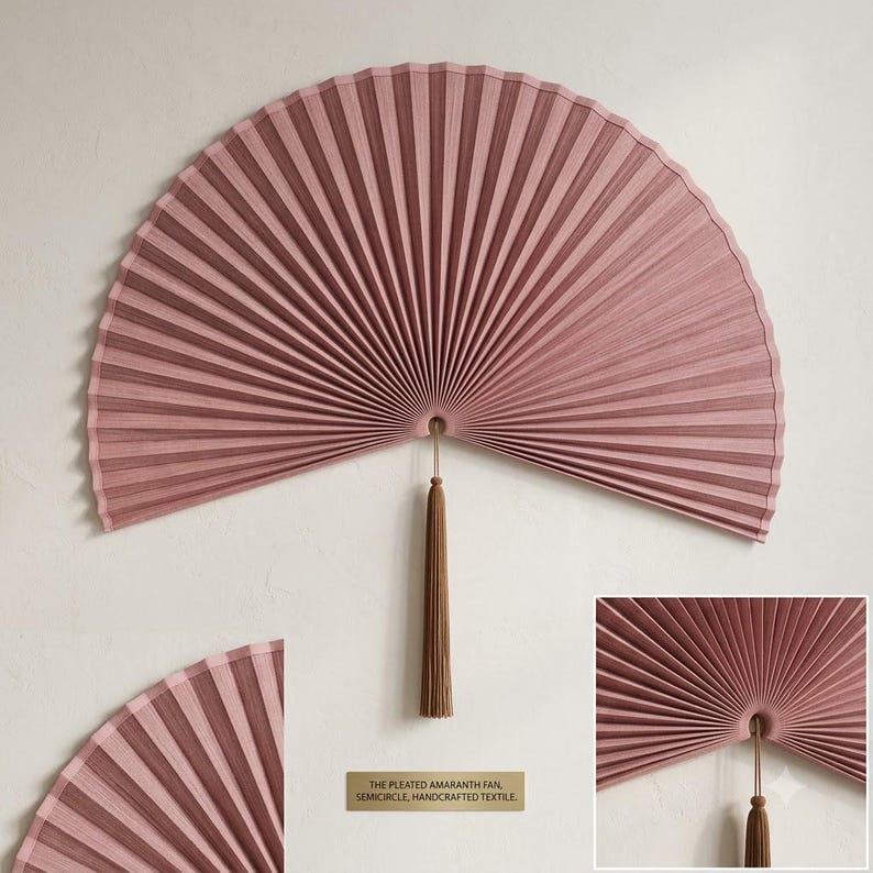 Oversized dusty rose bamboo wall fan styled above a wooden bed in a cozy neutral bedroom with soft natural light and minimalist decor.