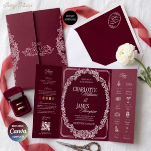 Puede incluir: Un conjunto de invitaciones de boda en color burdeos profundo con bordes de filigrana blanca, ilustraciones de cisnes y un marco ovalado central. Incluye un programa tríptico con cronograma, un sobre a juego y un joyero de terciopelo.