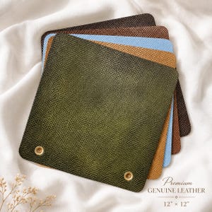 May include: A stack of square leather swatches with a textured snakeskin pattern, featuring colors including olive green, tan, light blue, and dark brown. Each 12 inch by 12 inch piece has two brass grommets. Text reads Premium GENUINE LEATHER 12 x 12.