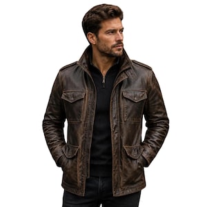 May include: A dark brown distressed leather field jacket featuring a high collar, four front flap pockets with snap closures, shoulder epaulets, and a front zipper closure layered over a black quarter-zip sweater and dark pants.