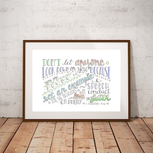 May include: A framed print with a colorful handwritten quote from the Bible, 1 Timothy 4:12. The quote reads "Don't let anyone look down on you because you are young, but set an example for the believers in speech, in conduct, in love, in faith, and in purity."