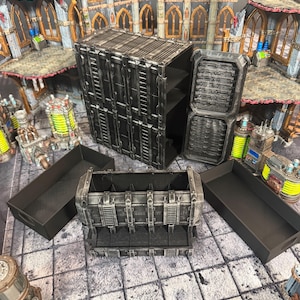 May include: A dark gray, industrial-style storage unit featuring a tall cabinet with an open door, a smaller rectangular base unit, and two separate black trays. The surfaces have a weathered, metallic finish with visible paneling and grid details.