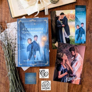 May include: A book titled A Courtship of Conspiracies by Marilee Merrell, featuring a blue cover with a couple on a street, accompanied by two character art prints, a bookmark, a square quote card, two small logo stickers, and dried lavender.