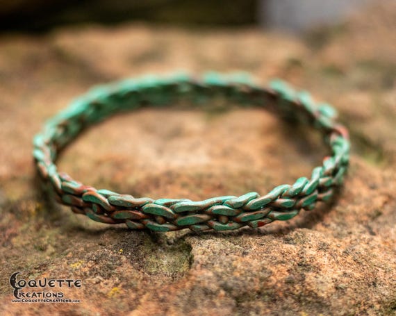 Hand hammered woven copper bangle finished with a beautiful ancient green patina