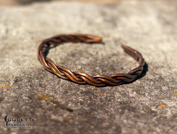 Hand hammered woven copper torc bracelet finished with a beautiful ancient bronze patina