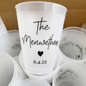 May include: A stack of white plastic cups with black text that reads "The Meriwethers" and "6.4.22" with a black heart symbol.