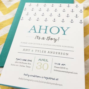 May include: A baby shower invitation with a nautical theme. The invitation features the words "AHoy, It's a Boy!" in blue and navy, with anchor illustrations. The invitation is on white cardstock with a teal envelope.