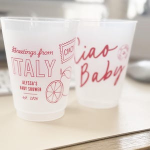May include: Two clear plastic cups with red text. The first cup says "Greetings from ITALY" with a stamp that says "CIAO". The second cup says "Ciao Baby".