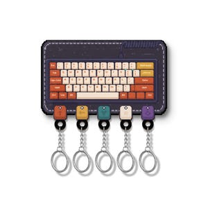 May include: A pixel art style display board featuring a dark purple keyboard with cream and orange keys. Below the keyboard are five square keycap-shaped charms in red, yellow, teal, cream, and purple, each attached to a silver metal keychain ring.