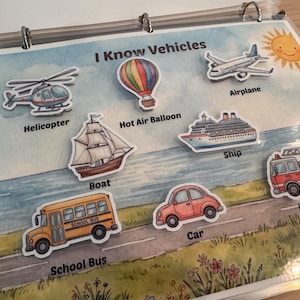 May include: A laminated educational page titled I Know Vehicles featuring watercolor illustrations of a helicopter, hot air balloon, airplane, boat, ship, fire engine, school bus, and car, each labeled with its corresponding name in black text.