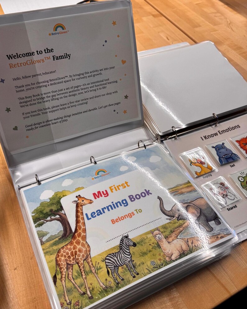 May include: A white three-ring binder containing educational activity pages. The cover features a colorful illustration of a giraffe, zebra, and llama in a landscape with the text My First Learning Book. An emotion chart shows animal icons.