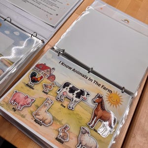 May include: A three-ring binder containing educational activity pages. One page titled I Know Animals In The Farm features illustrations of a rooster, duck, pig, alpaca, cow, rabbit, horse, and sheep, along with a smiling sun graphic.
