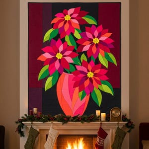 May include: A rectangular wall quilt featuring a vibrant floral arrangement of four large poinsettia flowers in shades of red, pink, and orange with yellow centers, set in a stylized orange vase against a dark background with geometric panels.
