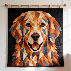May include: A wall hanging quilt featuring a geometric, pieced portrait of a golden retriever dog. The dog is composed of triangular fabric patches in shades of gold, brown, cream, and blue, set against a solid black background with visible stitching.