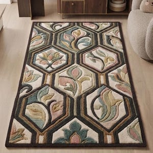 May include: A rectangular area rug featuring a repeating geometric pattern of dark brown hexagons. Each hexagon contains a raised, tufted floral motif in muted shades of sage green, dusty pink, cream, and tan, creating a textured, layered appearance.