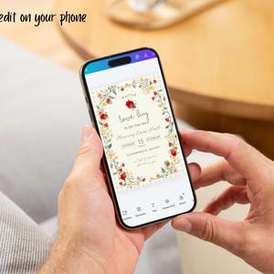 May include: A smartphone displaying a digital invitation template with the text 'A little love bug is on the way' surrounded by a floral border of red roses and yellow flowers. The screen includes editing icons and the text 'Easy to edit on your phone'.