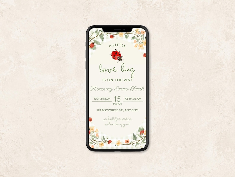 May include: A smartphone displaying a digital baby shower invitation with a ladybug and floral theme. The text reads A LITTLE love bug IS ON THE WAY, Honoring Emma Smith, SATURDAY 15 MARCH AT 10:00 AM, 123 ANYWHERE ST., ANY CITY, we look forward to welcoming you!
