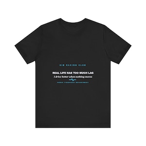 May include: A black short-sleeve t-shirt featuring the text SIM RACING CLUB, REAL LIFE HAS TOO MUCH LAG, I drive better when nothing moves, and FORCE FEEDBACK DEPARTMENT with a blue heartbeat line graphic printed on the center chest.