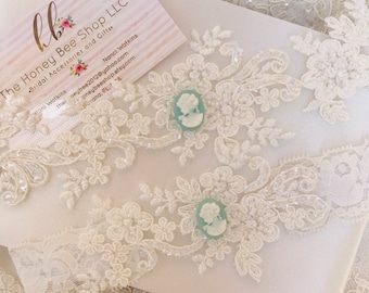 Light ivory wedding garter set with lovely cameo garter toss keepsake. Gorgeous lace bridal garter belt antique white cream plus size petite