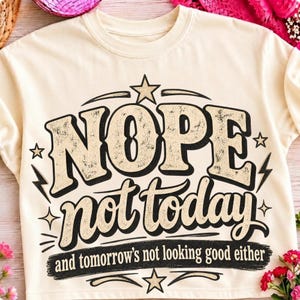 Könnte beinhalten: Ein cremefarbenes Sweatshirt mit Rundhalsausschnitt und einem Grafikdesign mit dem Text NOPE not today and tomorrow's not looking good either. Das Design enthält schwarze und beige Schriftzüge im Used-Look, Sterne und Blitze.
