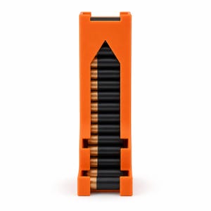 May include: A bright orange vertical battery storage dispenser holding a column of black and gold cylindrical batteries. The dispenser features an open front design with a pointed top cutout, allowing for easy access to the stacked batteries.