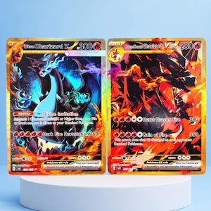 May include: Two rectangular trading cards featuring gold-toned borders and vibrant illustrations of dragon-like creatures. The left card is labelled Ultra Charizard Z with 300 HP, while the right card is labelled RozenKrauz Charizard VSTAR with 280 HP.